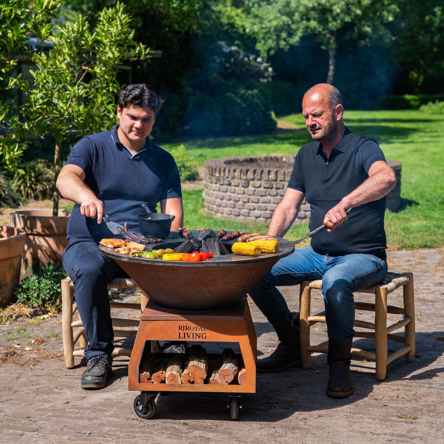 BBQ Plancha Grill Brasero Feuerschale Cortenstahl mit großen Rädern, Holzlager und Backblech Ø80cm